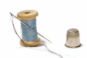 500267-spool-of-thread-with-needle